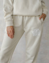Load image into Gallery viewer, Our World Needs Jesus Beige Unisex Sweatpant